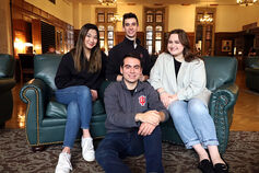 Group of smiling Cox Scholars, sitting together.